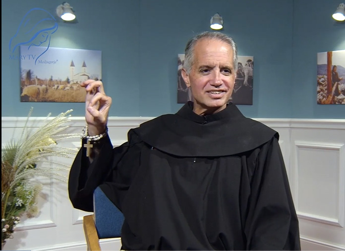 Fr. Michael motioning about the sun
    miracle, photo credit marytv.tv